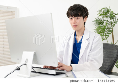 Male doctor wearing white coat 123413569