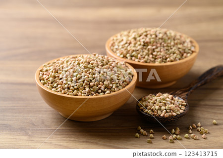 Organic buckwheat seed in wooden bowl with spoon, Food ingredient 123413715