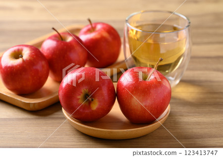 Red apple fruit and apple cider in glass on wooden background 123413747