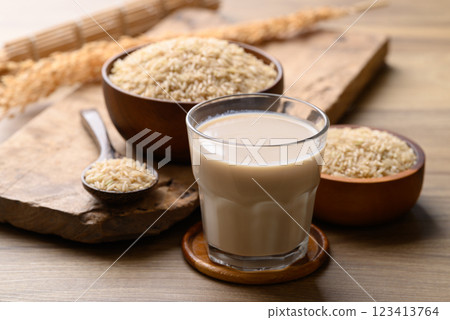 Organic rice milk in cup glass on wooden background, Alternative milk made from plant 123413764