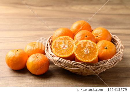 Mandarin tangerine orange fruit in basket on wooden background 123413779