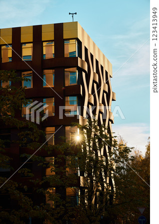 The Modern Architectural Design of a Truly Unique Building Against a Beautiful Sunset The Modern Architectural Design of a Truly Unique Building Against a Beautiful Sunset 123413949