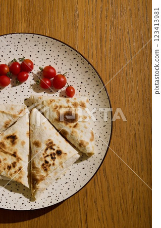 Freshly Grilled Flatbread with Vibrant Cherry Tomatoes for a Delightful Experience 123413981