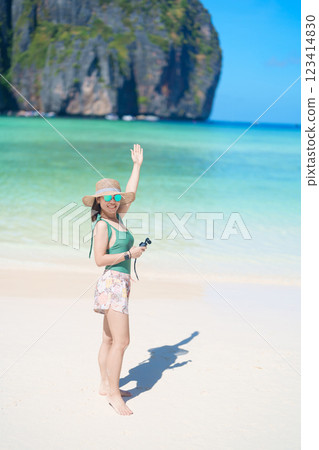 Woman tourist traveling and sightseeing in Krabi, Thailand, happy traveller enjoy at Maya Bay beach on Phi Phi island, Popular paradise island, destination, Southeast Asia Travel, vacation and holiday 123414830