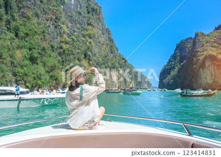 Woman tourist on boat trip, happy traveller relaxing at Pileh lagoon on Phi Phi island, Krabi, Thailand. Exotic landmark, destination Southeast Asia Travel, summer vacation and holiday concept 123414831