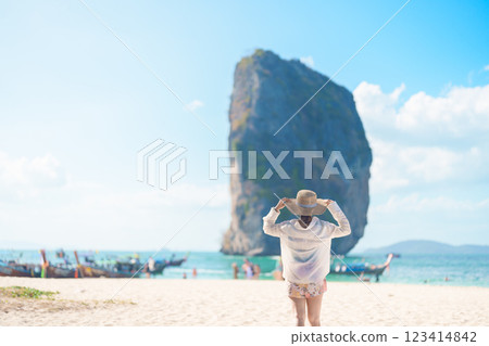 Woman tourist traveling and sightseeing in Krabi, Thailand. happy traveller enjoy on beach at Koh Poda island. summer trip, destination, Southeast Asia Travel, vacation and holiday concept 123414842