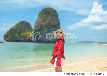 Woman tourist travel and sightseeing in Krabi, Thailand. happy traveller enjoy on beach at Phra nang Cave Beach near Railay Beach. summer trip, destination, Southeast Asia Travel and vacation concept 123414847