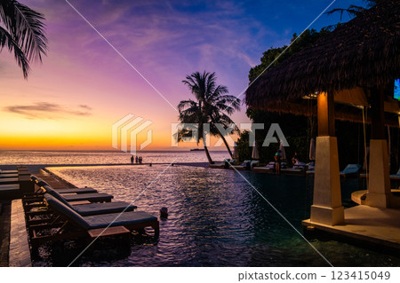 Sunset views from overwater pool villa in Maldives 123415049