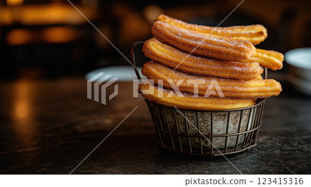 Fresh churros stacked in vintage basket, perfect for dessert lovers Fresh churros stacked in vintage basket, perfect for dessert lovers 123415316