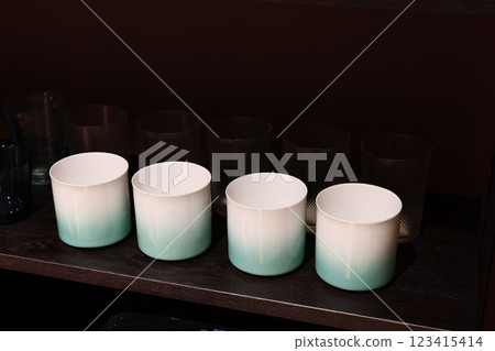 A Set of Elegant Gradient Mugs Captivatingly Displayed on a Beautiful Wooden Shelf A Set of Elegant Gradient Mugs Captivatingly Displayed on a Beautiful Wooden Shelf 123415414