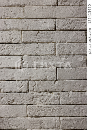 A textured background with a white brick wall, providing a clean aesthetic for designs 123415430