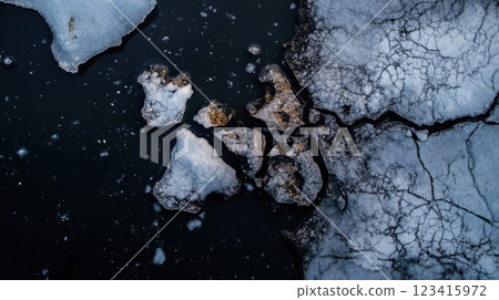 Cracked icebergs floating in dark water, showcasing nature beauty and fragility 123415972