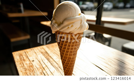 Creamy vanilla ice cream cone with soft swirl on wooden table Creamy vanilla ice cream cone with soft swirl on wooden table 123416014