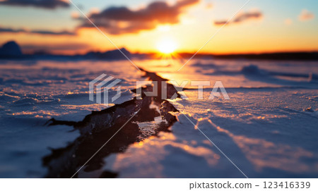 close up view of cracks in polar ice with water seeping at sunset close up view of cracks in polar ice with water seeping at sunset 123416339