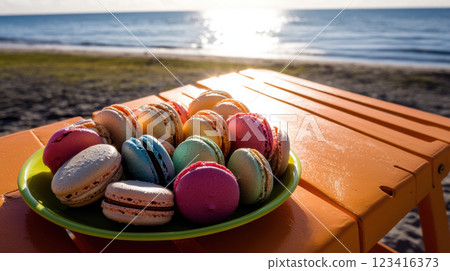 Colorful macarons on bright plate by beach at sunset Colorful macarons on bright plate by beach at sunset 123416373