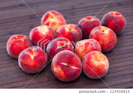 Juicy ripe peaches on wooden table 123416815