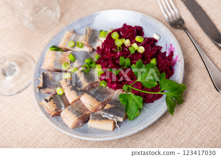 Lightly salted herring with beets served on platter 123417030