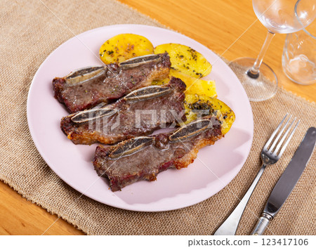 Churrasco de ternera, grilled veal spare ribs with garnish of french fries Churrasco de ternera, grilled veal spare ribs with garnish of french fries 123417106