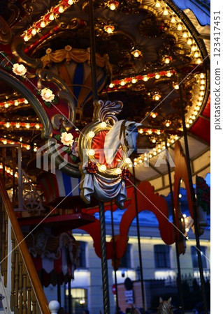 The Whimsical Carousel at Night is Beautifully Illuminated by Bright Festive Lights and Colors The Whimsical Carousel at Night is Beautifully Illuminated by Bright Festive Lights and Colors 123417451