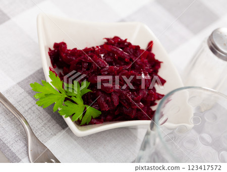 Traditional salad of Russian cuisine from boiled grated beetroot, decorated with sprig of parsley Traditional salad of Russian cuisine from boiled grated beetroot, decorated with sprig of parsley 123417572