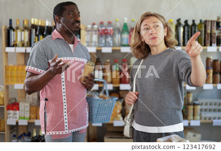 Couple man and woman choosing food in grocery store 123417692