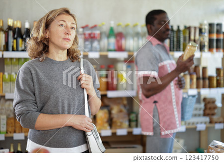 Adult woman choosing food in grocery store 123417750