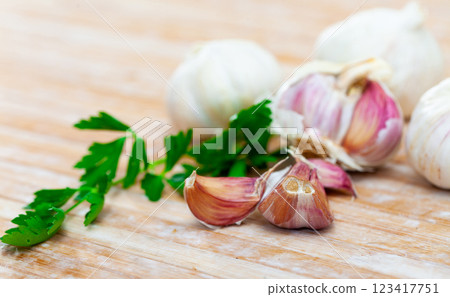 Fresh parsley and garlic on wooden table 123417751