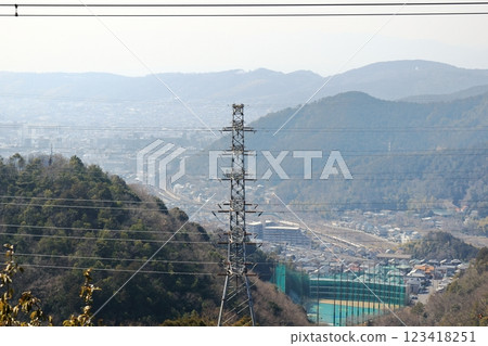 Electricity transmission tower and the hazy mountains and city of Kyoto Electricity transmission tower and the hazy mountains and city of Kyoto 123418251