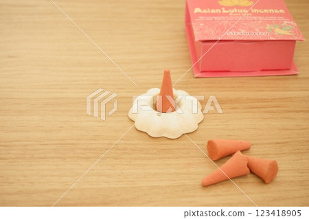 Cone-shaped incense in an incense stand Cone-shaped incense in an incense stand 123418905