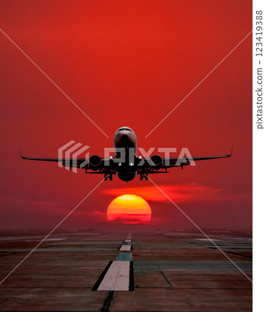 Passenger aircraft take off from airport runway against the backdrop picturesque sunrise Passenger aircraft take off from airport runway against the backdrop picturesque sunrise 123419388