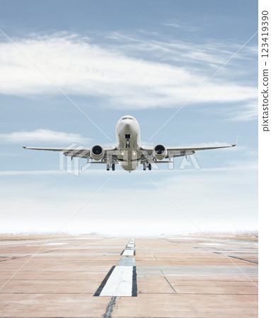 White passenger airliner take off from airport runway White passenger airliner take off from airport runway 123419390