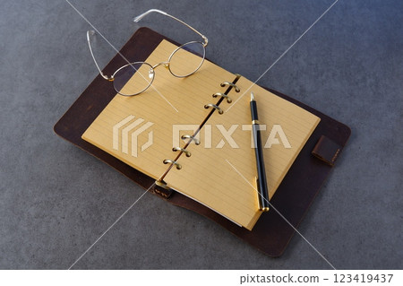 Image of a ring-type system organizer being opened and writing a diary Image of a ring-type system organizer being opened and writing a diary 123419437