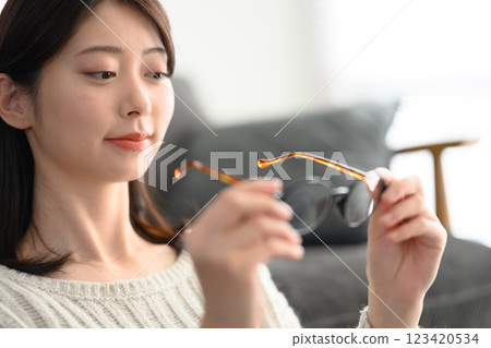 Woman holding glasses in hand Woman holding glasses in hand 123420534