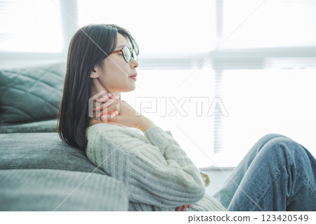 Upper body of a woman with her hands on her neck Upper body of a woman with her hands on her neck 123420549