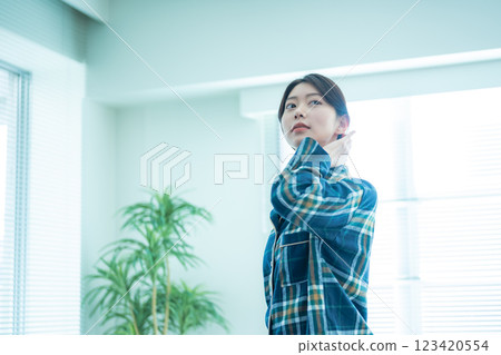 Woman fixing her hair by the window 123420554