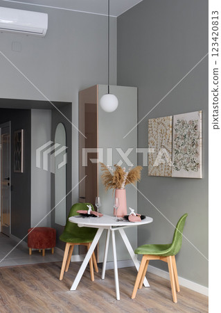 A Modern Dining Area Featuring Stylish Decor and Beautiful Green Accents That Inspire A Modern Dining Area Featuring Stylish Decor and Beautiful Green Accents That Inspire 123420813