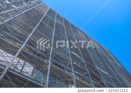 Yokohama cityscape in Japan - View of scaffolding and protective netting set up for repairs and inspections of apartment buildings (Yokohama city) 123421123
