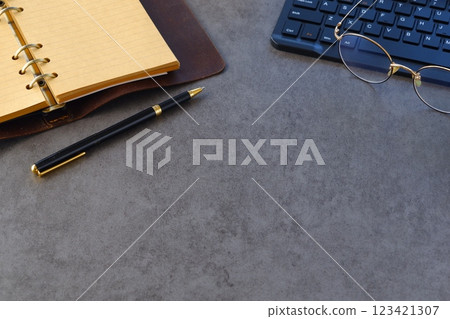 Image of a ring-type system organizer open and doing desk work on a laptop 123421307