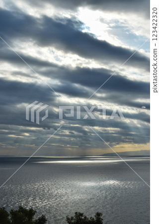A fantastic morning with sunlight falling through the clouds onto the sea 123422320