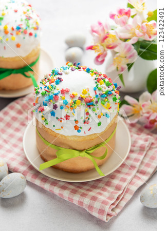 Traditional easter cakes decorated with colorful sprinkles and eggs on festive table 123422491