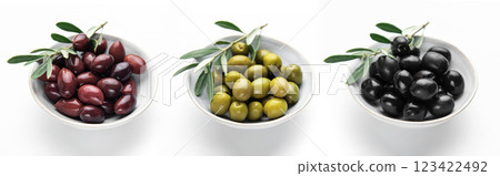 Black, green and kalamata olives with olive branches in bowls Black, green and kalamata olives with olive branches in bowls 123422492