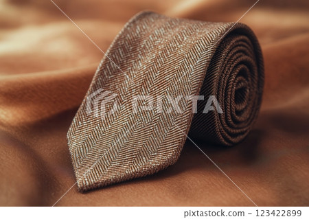 Elegant Necktie with Herringbone Pattern on Luxury Fabric Background 123422899