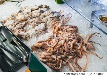 Asian seafood on display at Asian night Market in Vietnam. Fresh octopus and squid on ice Asian seafood on display at Asian night Market in Vietnam. Fresh octopus and squid on ice 123423008