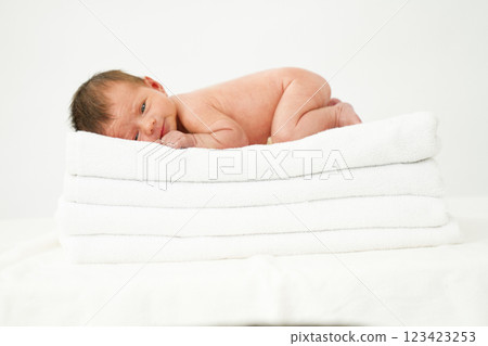 Newborn baby girl sleeps on a towel 123423253