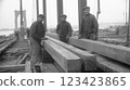Vintage skyline: A black and white depiction of early twentieth century bridge and skyscraper construction, architectural ambition and industrial progress of an era, rise of urban landscapes. 123423865