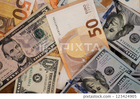 Dollar bills with euro banknotes placed on table demonstrate concept of tight correlation in exchange rate of dominant currencies in global monetary system 123424905