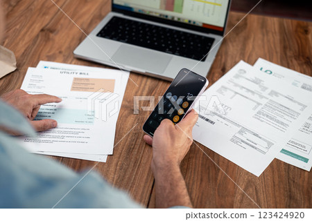 Aged man financial specialist uses smartphone counting total utility bills at office workplace, senior male worker checks household expenses, invoices payment plan Aged man financial specialist uses smartphone counting total utility bills at office workplace, senior male worker checks household expenses, invoices payment plan 123424920