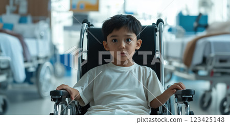 young boy in wheelchair looks thoughtfully in hospital setting 123425148