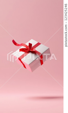White closed gift box wrapped with red ribbon floating on pastel pink background, perfect for valentine's day, women's day, mother's day, birthday or other special occasions 123425246