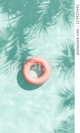 Minimalist summer background showing a pink inflatable ring floating on turquoise water, with palm tree shadows adding a touch of tropical vibes, perfect for holiday and travel concepts 123425441